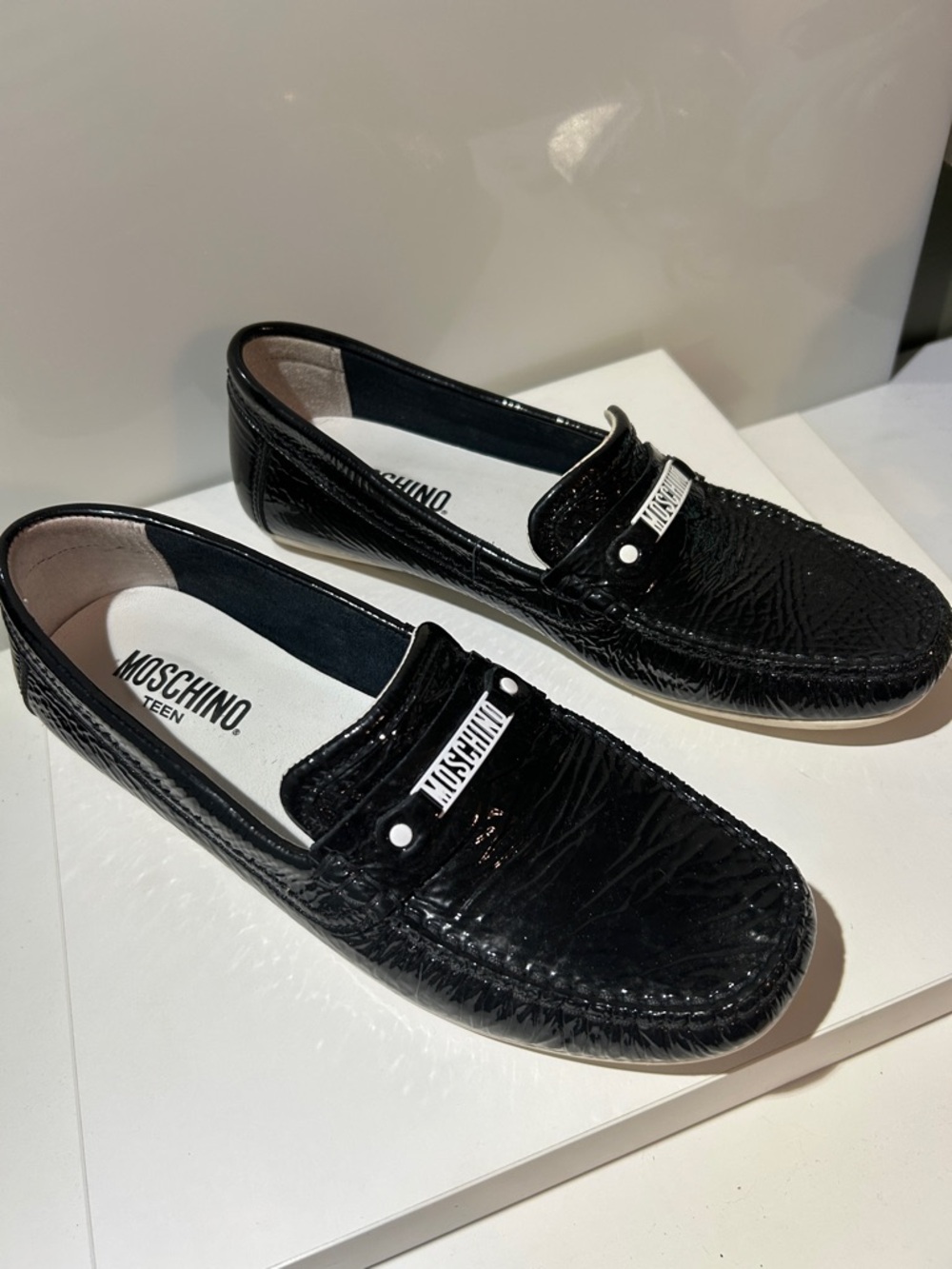 Moschino Teen Black Patent Leather Slip-On Loafers with metal white Logo Accent